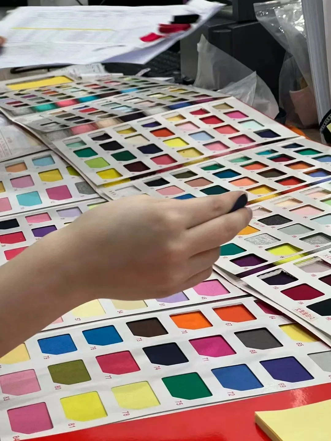 Fabric color swatches being reviewed for custom color matching