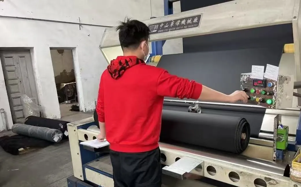 Operator inspecting finished fabric on an inspection machine