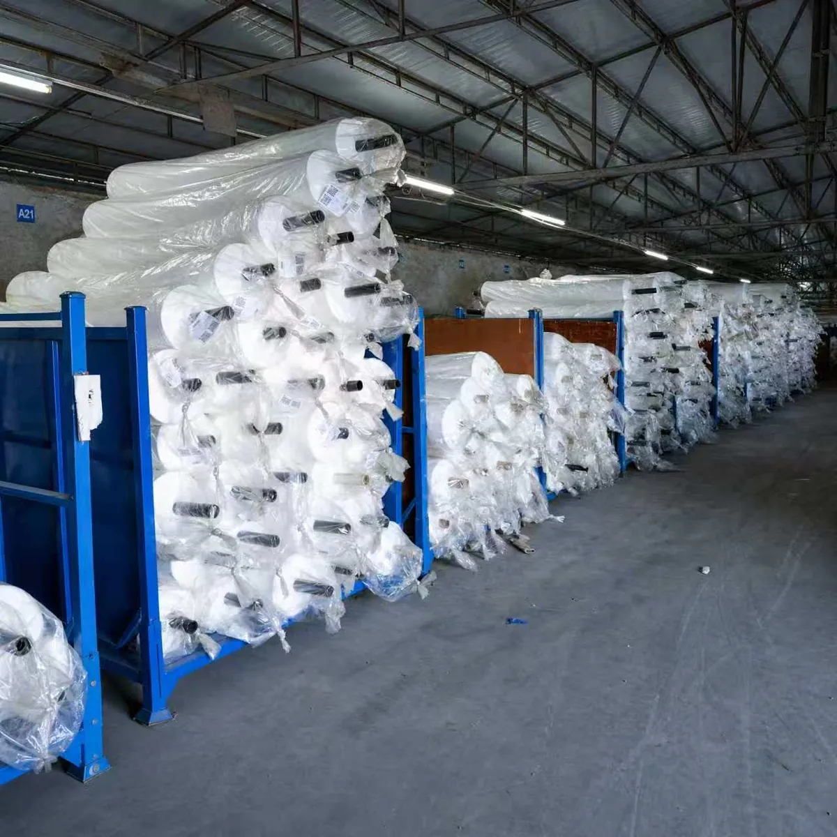 Warehouse racks holding fabric rolls ready for bulk supply